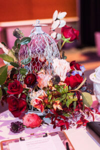 eco-friendly flower arrangement in a bird cage for use for a sustainable wedding